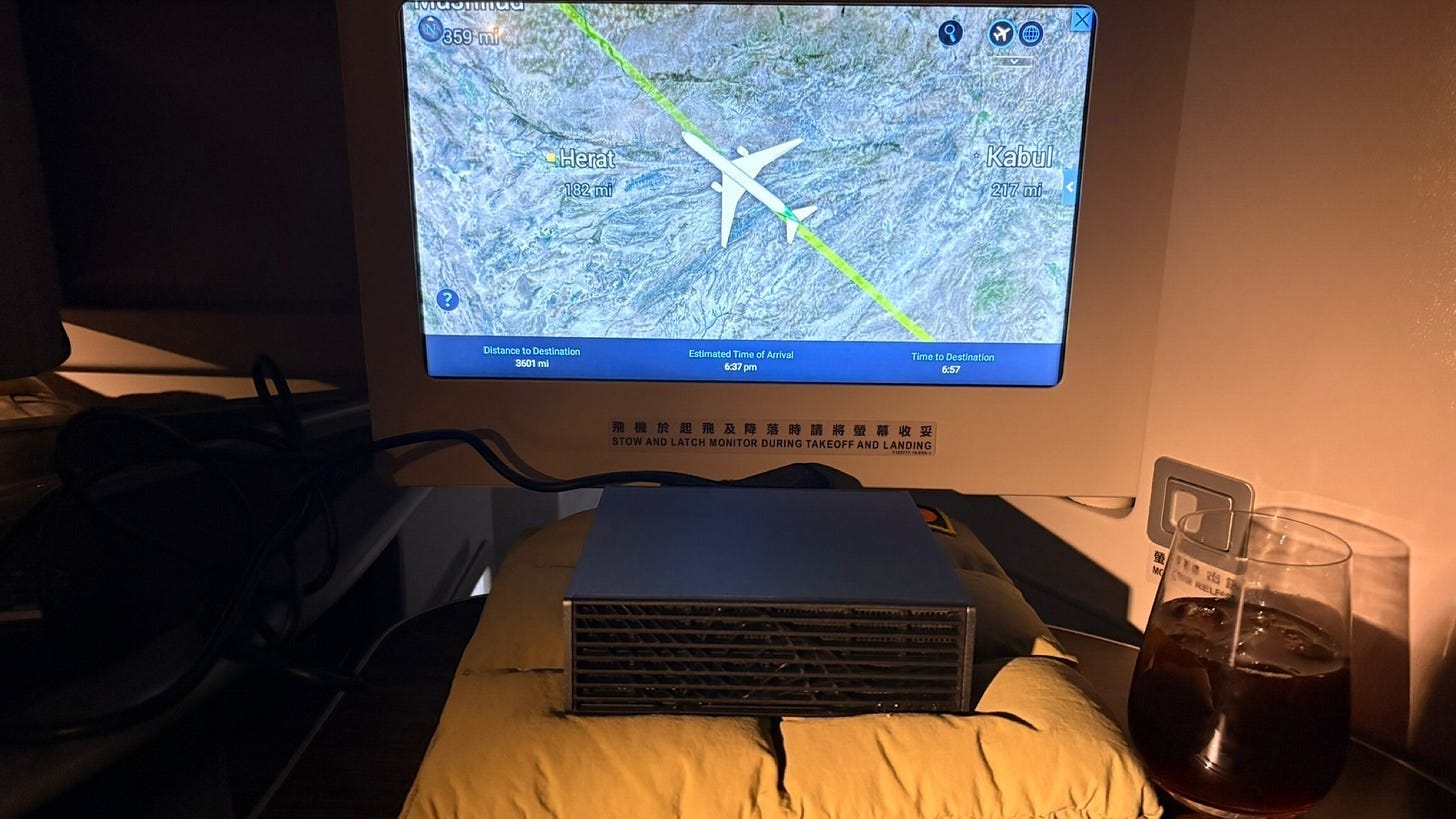 Airline seat-back sign: “Stow and latch monitor during takeoff and landing”